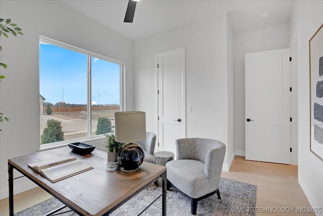 home office with ceiling fan and light wood-type flooring