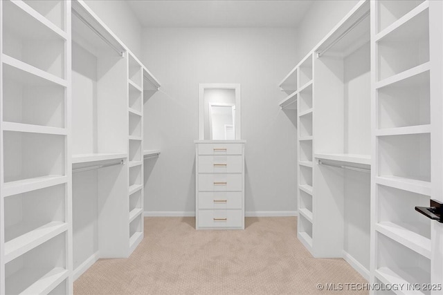 walk in closet featuring light carpet