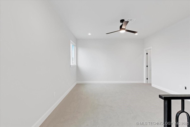 carpeted spare room featuring ceiling fan