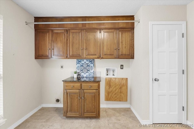 laundry area with cabinets, electric dryer hookup, hookup for a washing machine, and light tile patterned floors