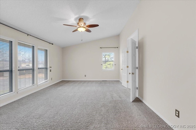 spare room with vaulted ceiling, carpet flooring, ceiling fan, and a textured ceiling