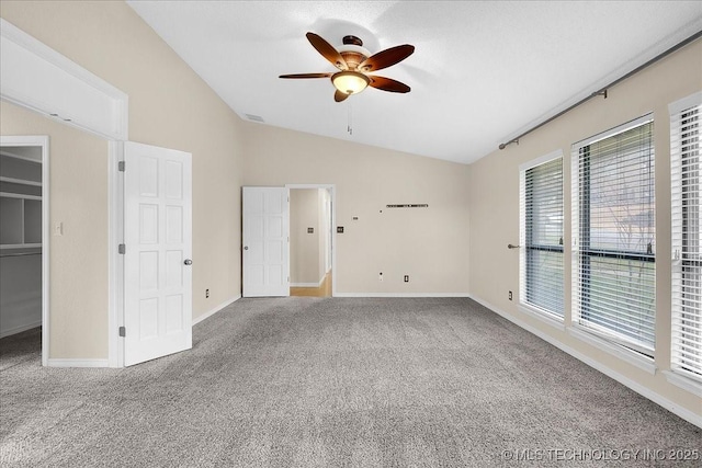 unfurnished bedroom with lofted ceiling, ceiling fan, and carpet flooring