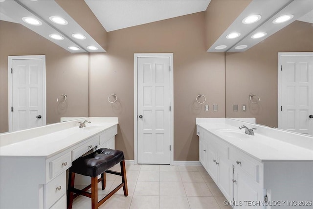 bathroom with vanity, tile patterned flooring, and vaulted ceiling