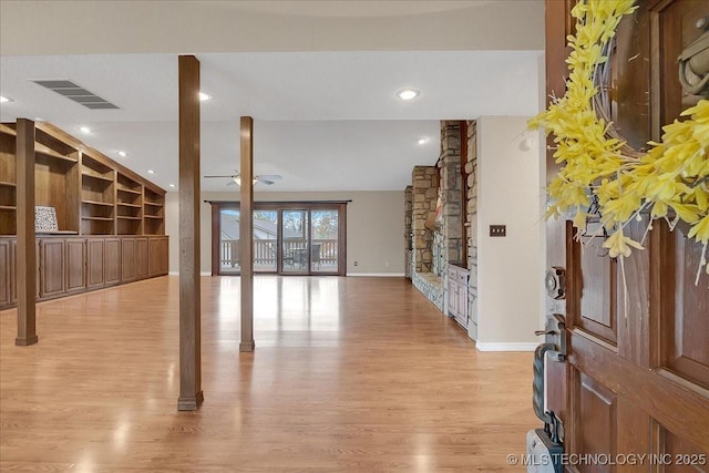 living room with built in shelves, ceiling fan, lofted ceiling, and light hardwood / wood-style flooring