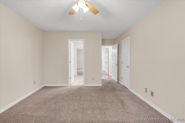 carpeted spare room with ceiling fan and a textured ceiling