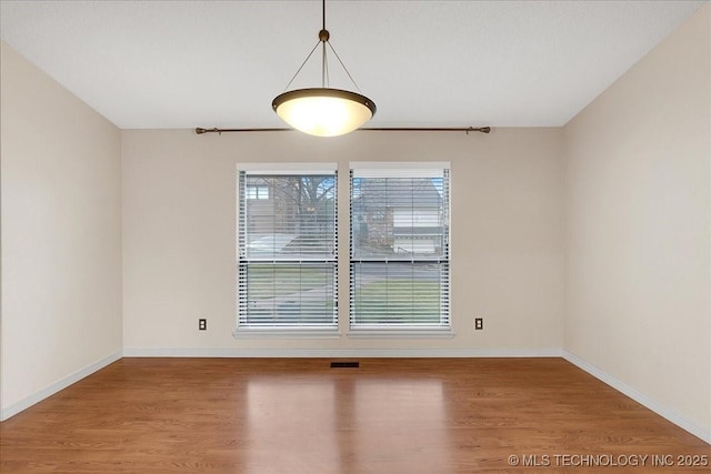 unfurnished room with hardwood / wood-style flooring