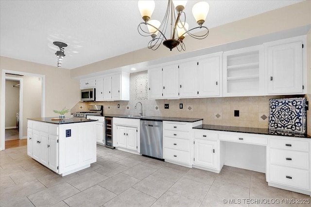 kitchen with white cabinetry, stainless steel appliances, wine cooler, and pendant lighting