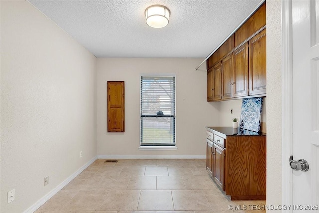 kitchen featuring light tile patterned floors and a textured ceiling