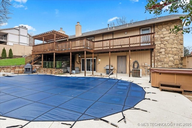 view of swimming pool with area for grilling, a hot tub, a deck, and a patio