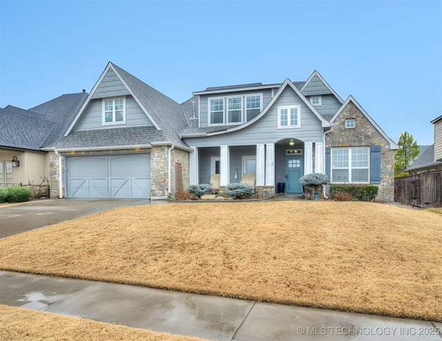 craftsman-style house featuring a garage and a front lawn