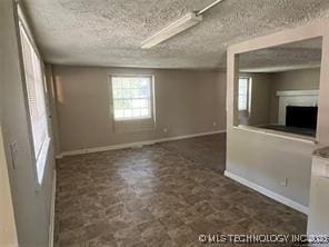 unfurnished living room with a textured ceiling