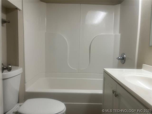 full bathroom with vanity, toilet, and washtub / shower combination