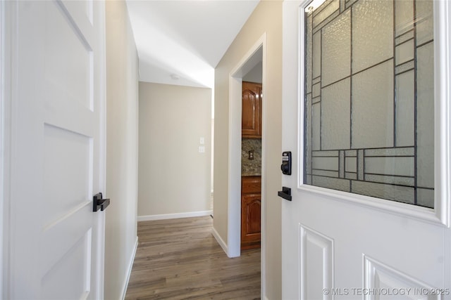 hall with hardwood / wood-style flooring