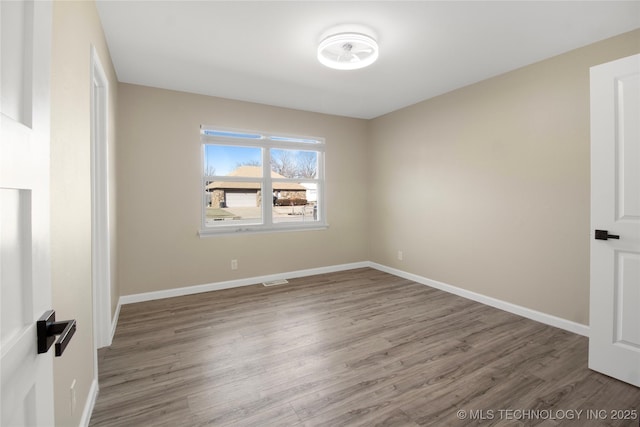 unfurnished room featuring hardwood / wood-style flooring