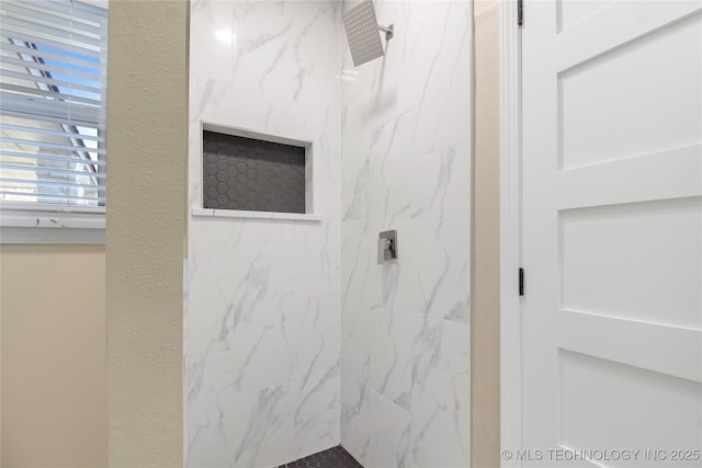 bathroom with a tile shower