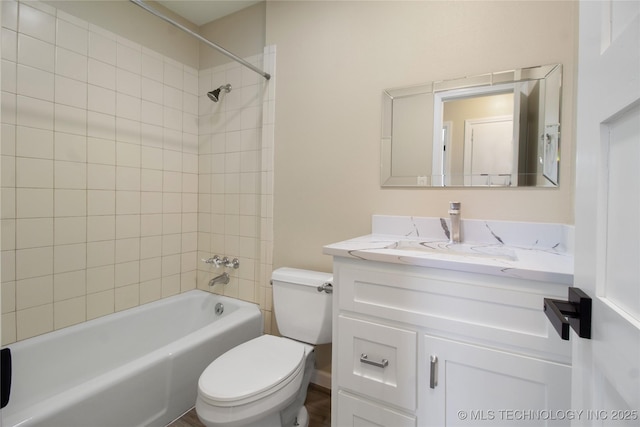 full bathroom featuring vanity, toilet, and tiled shower / bath combo