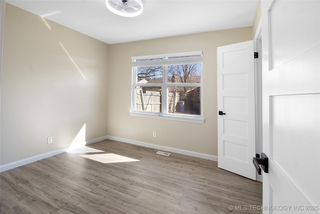 unfurnished room featuring wood-type flooring