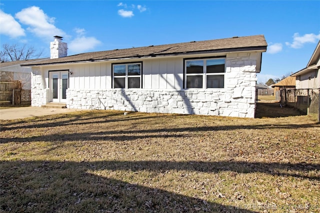 rear view of house featuring a yard