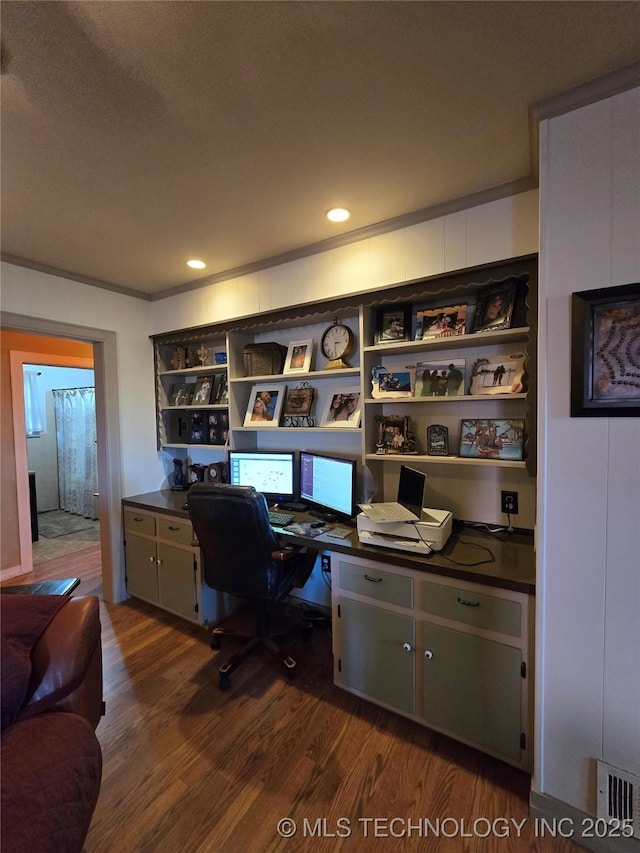 office featuring ornamental molding, dark hardwood / wood-style flooring, and built in desk