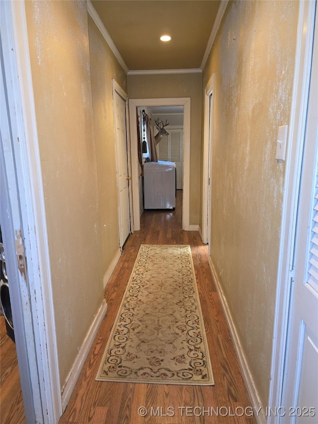 corridor with hardwood / wood-style flooring and ornamental molding