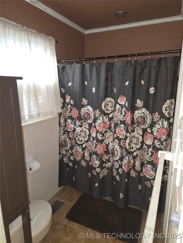 bathroom featuring tile walls, crown molding, tile patterned floors, and toilet