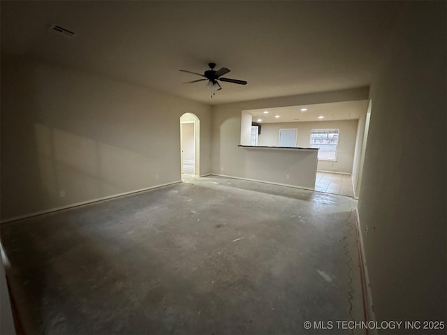 spare room featuring ceiling fan and concrete flooring