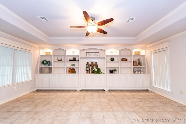 empty room featuring crown molding, ceiling fan, and a tray ceiling