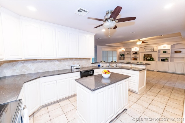 kitchen with dishwasher, a center island, light tile patterned floors, and kitchen peninsula