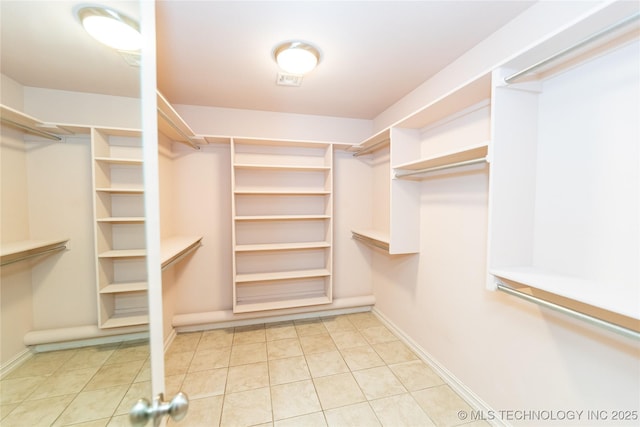 walk in closet with tile patterned floors