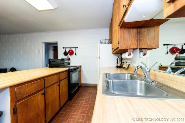 kitchen featuring white refrigerator, sink, and electric range