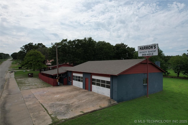 view of home's exterior featuring a garage and a yard