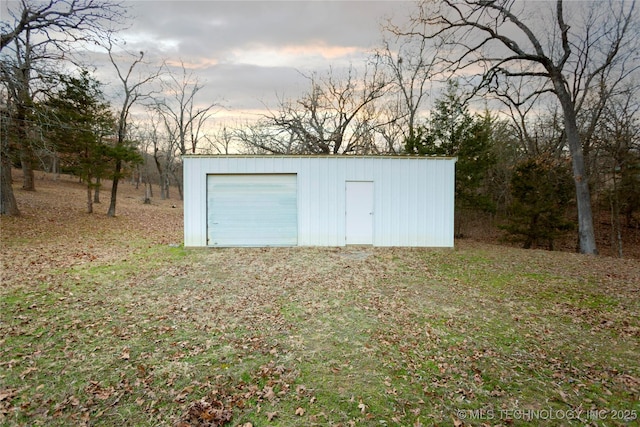 outdoor structure at dusk featuring a garage