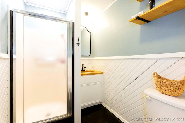 bathroom with vanity, a shower with shower door, and toilet