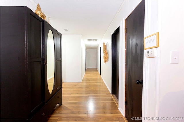 hallway with light hardwood / wood-style floors