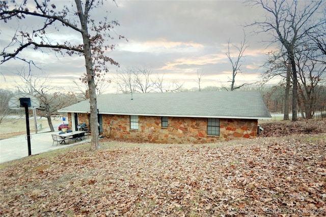 view of property exterior with a patio area