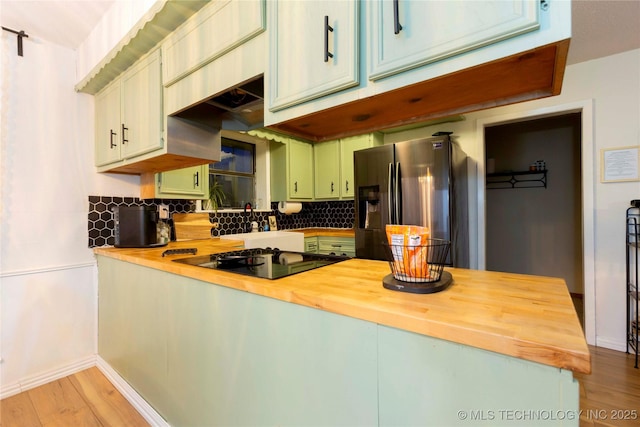 kitchen with tasteful backsplash, stainless steel fridge with ice dispenser, light hardwood / wood-style flooring, kitchen peninsula, and black electric stovetop