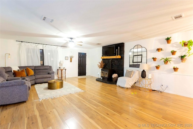 living room featuring hardwood / wood-style floors and ceiling fan