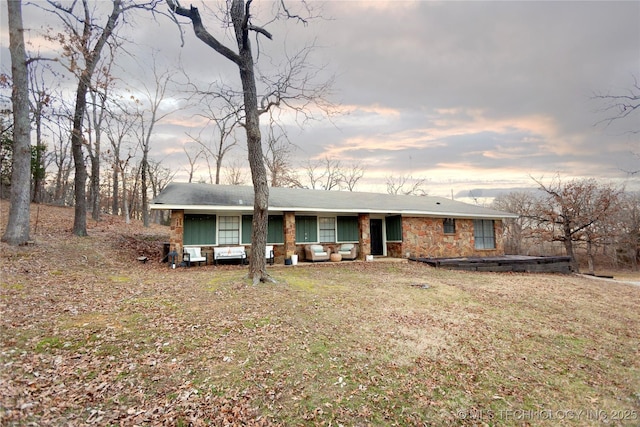 ranch-style home with a yard and a porch