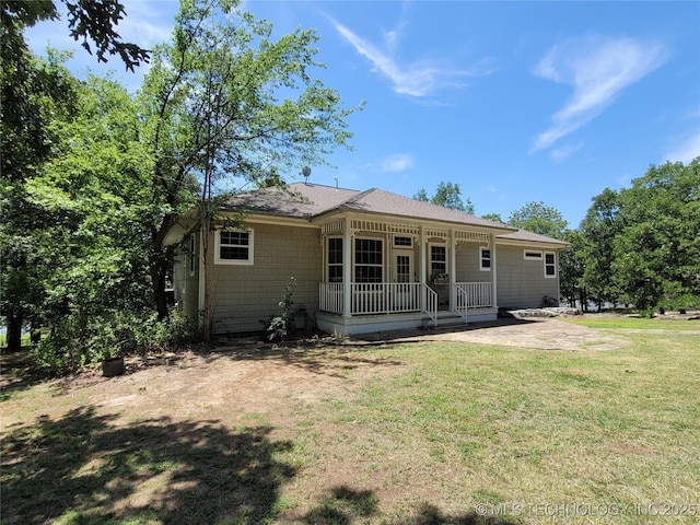 back of property with a patio area and a lawn