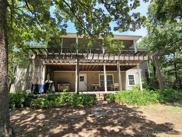 rear view of house with a pergola and a patio