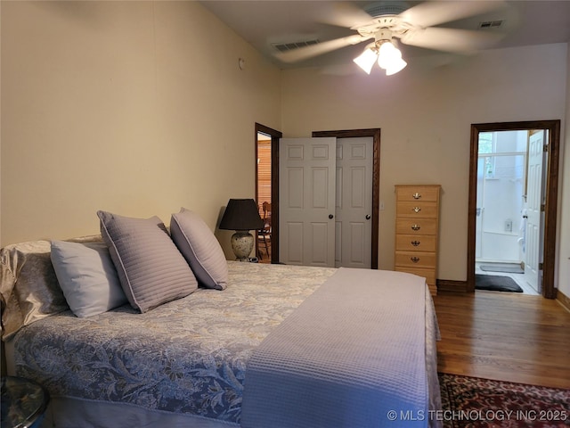 bedroom with dark hardwood / wood-style floors, ceiling fan, and a closet