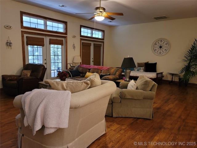 living room with dark hardwood / wood-style floors, french doors, and ceiling fan