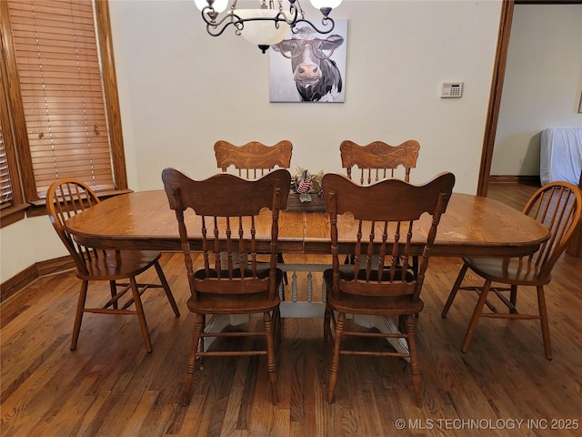 dining room featuring an inviting chandelier and wood-type flooring