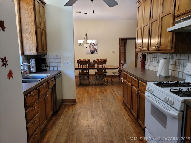 kitchen with decorative light fixtures, sink, hardwood / wood-style flooring, stainless steel dishwasher, and gas range gas stove