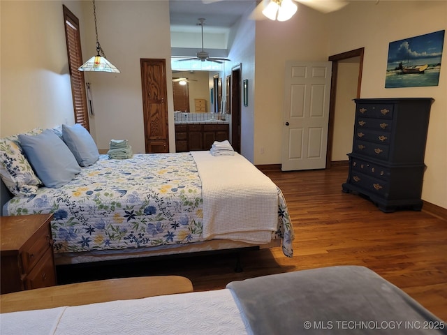 bedroom with wood-type flooring and ensuite bathroom