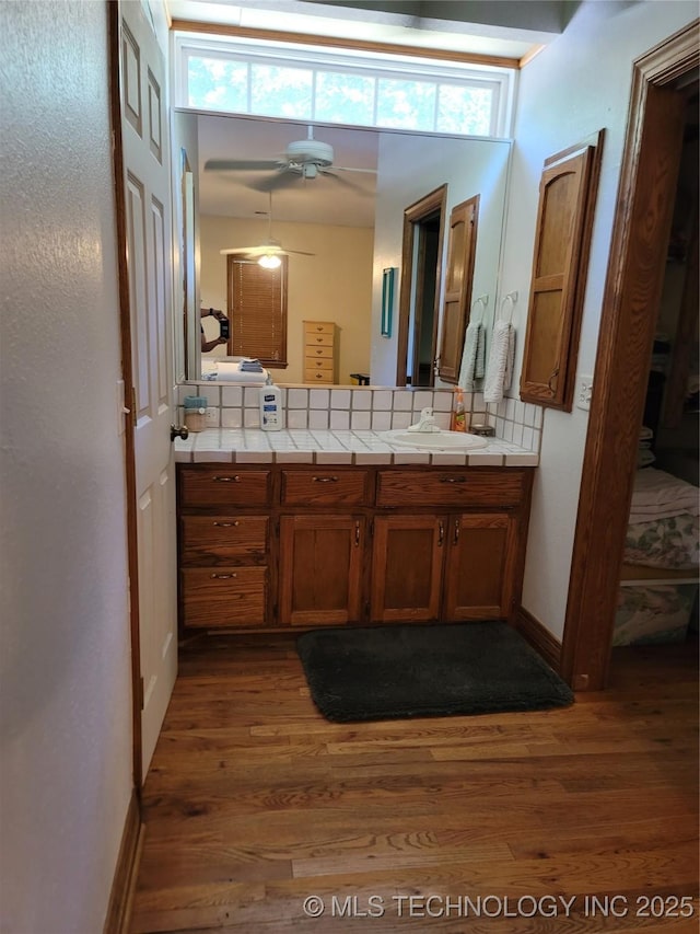 bathroom with vanity, wood-type flooring, and plenty of natural light