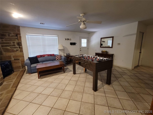 rec room with light tile patterned floors and ceiling fan