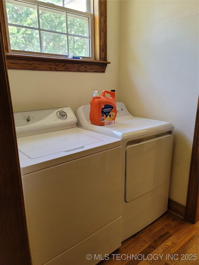 clothes washing area with washer and dryer and dark hardwood / wood-style floors