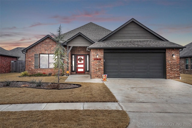 view of front of house featuring a garage and a lawn