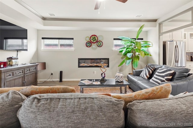 living room with ceiling fan and light wood-type flooring